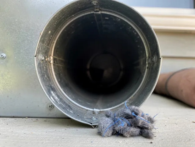 Fairfield Dryer Vent Cleaning technician using specialized equipment to clear severe dryer vent blockage in Fairfield